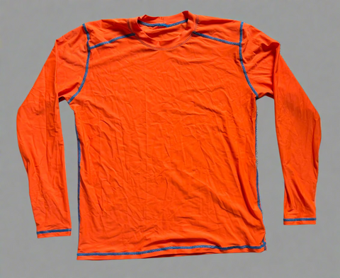 Orange long-sleeve shirt with blue accents on a gray surface